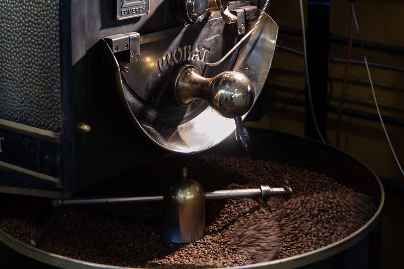 Coffee roaster with coffee beans on a dark background